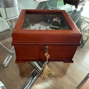 Mr. Christmas illuminated wood music box featuring an animated ice-skating scene